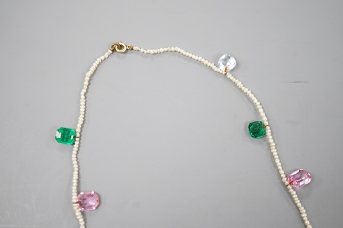 A multi coloured paste and opal doublet set baroque seed pearl necklace, 42cm.